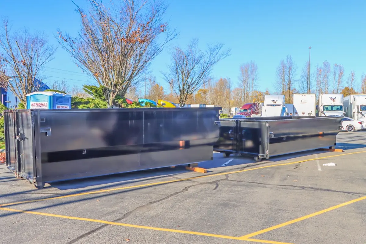 Professional dumpster rental service with roll-off container on residential driveway in Camp Pendleton South